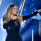 Illustration for article titled All I Want For Christmas Is...the Bag: Mariah Careys Holiday Staple Hits No. 1 on Billboard for First Time, New Music Video to Come
